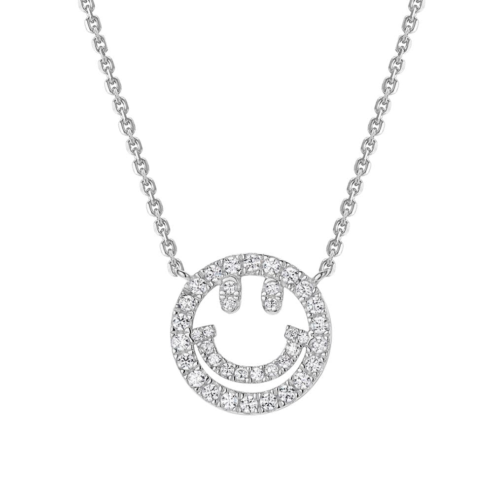 A close-up of a silver necklace featuring a circular smiley face pendant encrusted with tiny pavé simulated diamond, displayed on a white background.